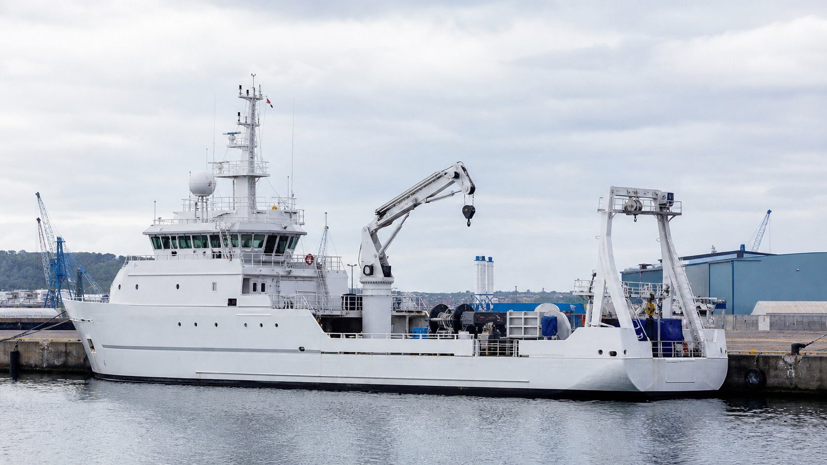 Special purpose vessel with mission-specific deck equipment at a quay, illustrating the range of research, survey and support craft in this class
