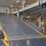 AI-generated illustration of an internal RoRo vehicle ramp beside supported movable car-deck panels